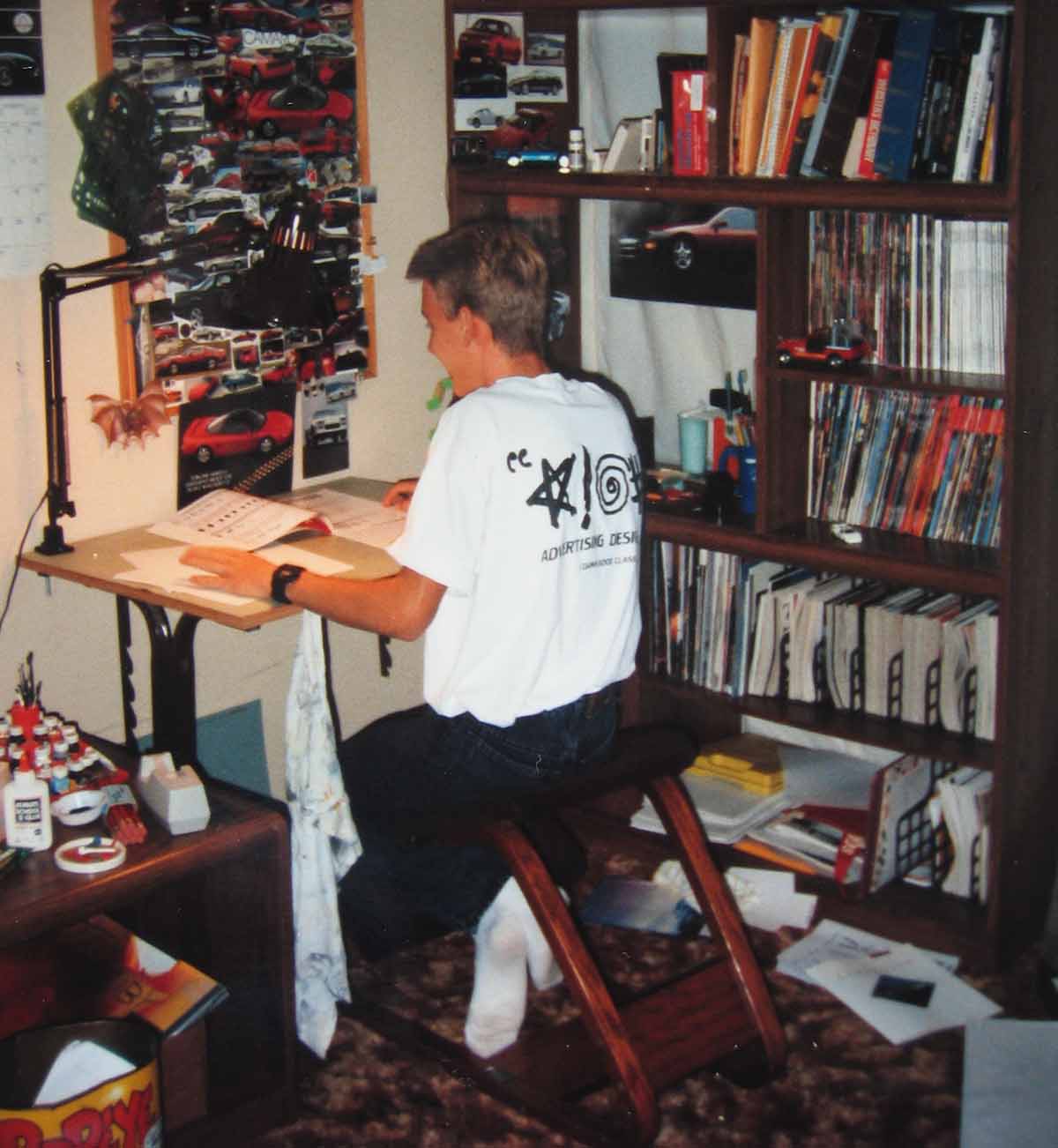 A picture of me drawing cars at my desk in 1992